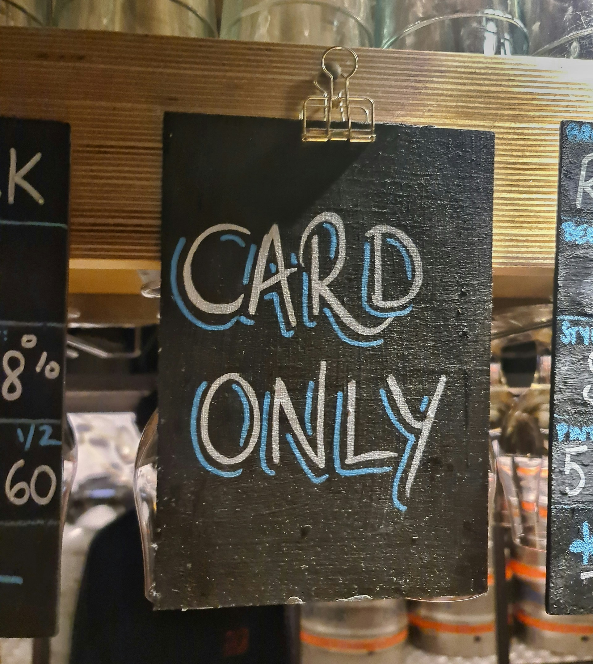 Handwritten 'Card Only' sign at a bar, reflecting the shift away from cash payments